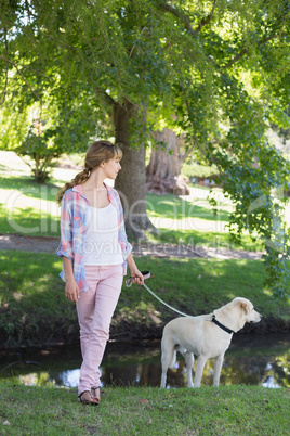 Cute blonde with her labrador dog in the park