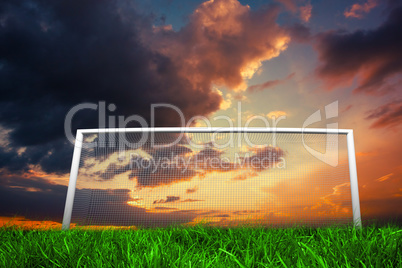 Football goal under orange cloudy sky