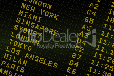 Black airport departures board with yellow text