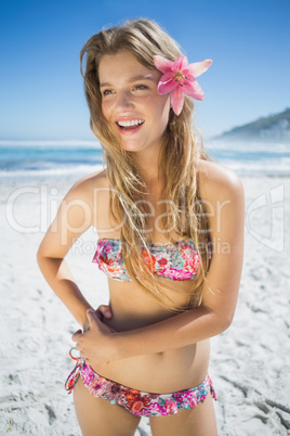 Beautiful smiling blonde with flower hair accessory on the beach