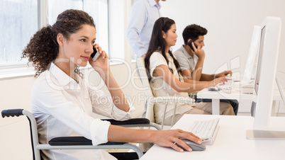 Casual businesswoman in wheelchair on the phone