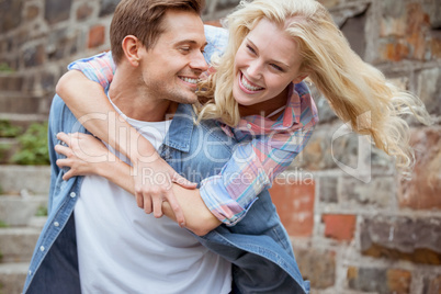 Man giving his pretty girlfriend a piggy back