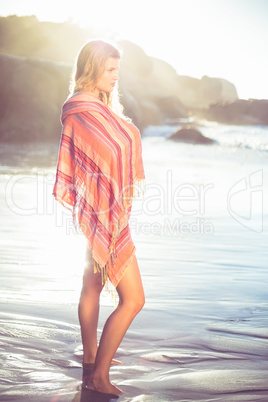 Beautiful blonde wrapped in scarf at the beach