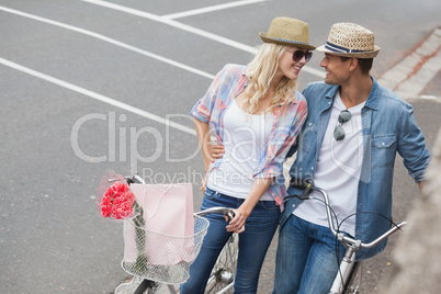 Hip young couple going for a bike ride