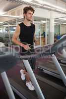 Fit man jogging on the treadmill