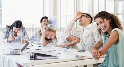 Casual business team laughing during meeting