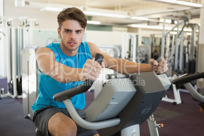 Focused man on the exercise bike