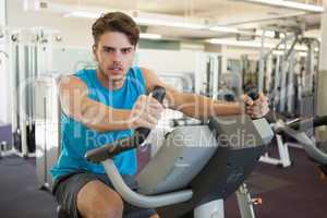 Focused man on the exercise bike