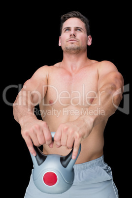 Focused bodybuilder swinging up kettlebell