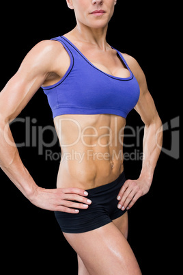 Strong woman posing with hands on hips