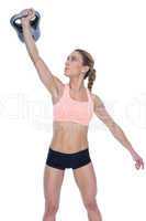 Female crossfitter lifting up kettlebell