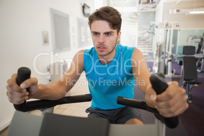Focused fit man on the exercise bike Focused fit man on the exercise bike