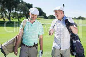 Golfer friends walking and chatting