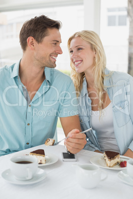 Hip young couple having desert and coffee together