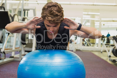 Fit man balancing on exercise ball