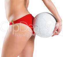 Fit girl in bikini holding football