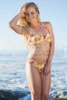 Gorgeous blonde in floral bikini posing at the beach