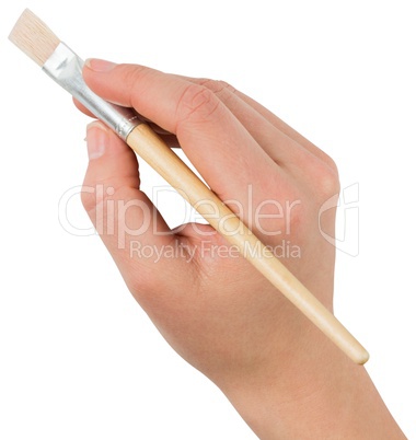 Hand holding paintbrush