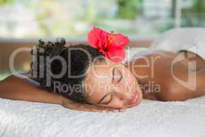 Gorgeous woman lying on massage table with salt treatment on bac
