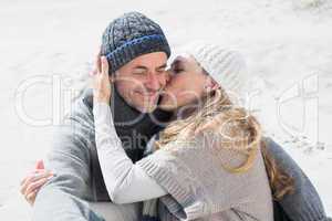 Attractive couple on the beach in warm clothing