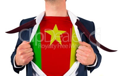 Businessman opening shirt to reveal cameroon flag