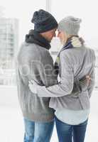 Cute couple in warm clothing hugging