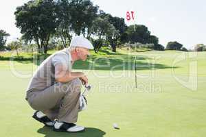 Golfer on the putting green at the eighteenth hole