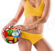 Fit girl in yellow bikini holding flag football