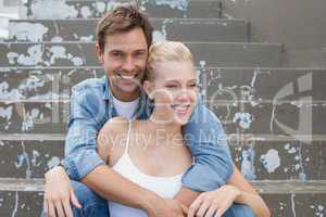 Hip young couple sitting on steps