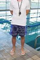 Swimming coach standing by the pool