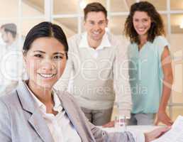 Casual businesswoman smiling at camera during meeting