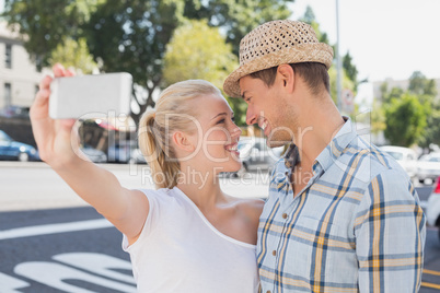 Young hip couple taking a selfie