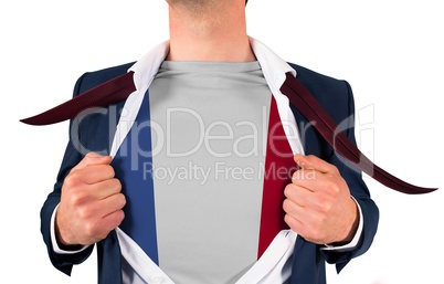 Businessman opening shirt to reveal france flag