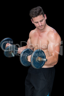 Strong crossfitter lifting heavy black dumbbells