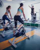 Spin class working out with motivational instructor