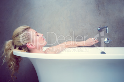 Serene blonde lying in the bath