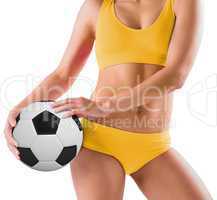 Fit girl in yellow bikini holding football