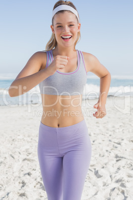 Sporty blonde jogging on the beach Sporty blonde jogging on the beach