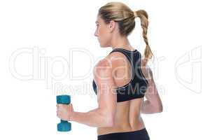 Female bodybuilder holding a blue dumbbell