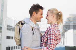 Hip young couple smiling at each other