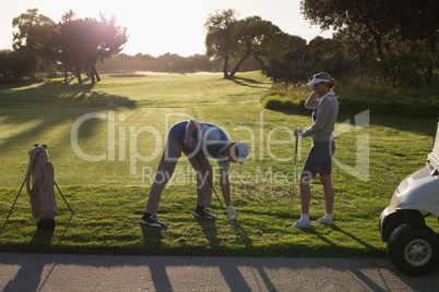 Golfing couple teeing off for the day