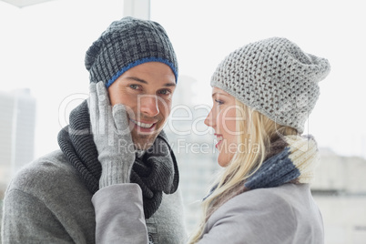 Cute couple in warm clothing hugging