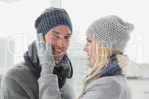 Cute couple in warm clothing hugging