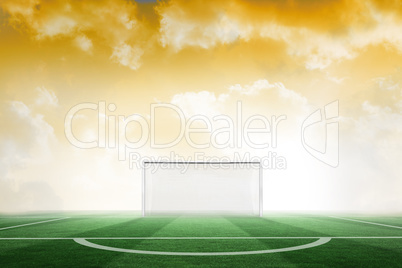 Football pitch under yellow sky