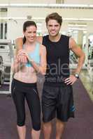 Fit attractive couple smiling at camera