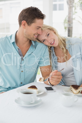 Hip young couple having desert and coffee together