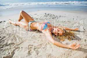 Gorgeous blonde in bikini lying on the beach