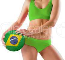 Fit girl in green bikini holding brasil ball