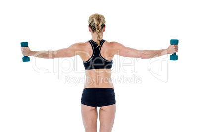 Female bodybuilder holding two dumbbells with arms out