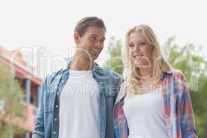 Hip young couple smiling and standing